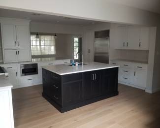 U-shaped kitchen with island, peninsula & wet bar. Cabinetry by CABICO. Cabinets are black and white