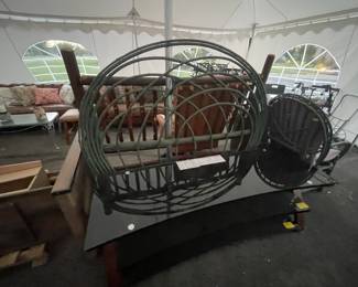 Green wicker headboard and glass entertainment console