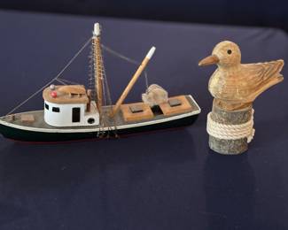 Minature lobster boat and pelican on boat tie