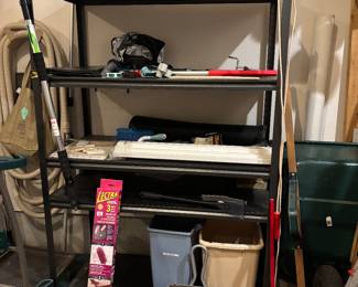 Shelves are for sale - brooms, watering cans, over size dust pans, leaf gatherer, waste baskets, cleaning supplies