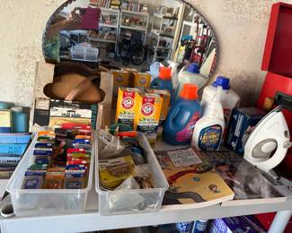 Oval wall mirror, packages of household keepers, irons, cleaners, brass trim in holder, yards of it!