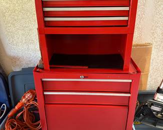 Rolling red metal tool chest shown closed