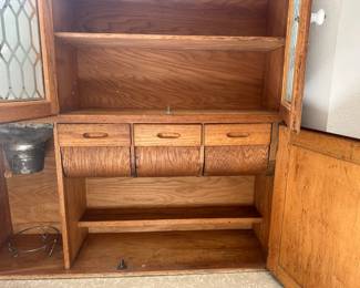 Inside of top section with complete flour sifter, pull down curved drawers,