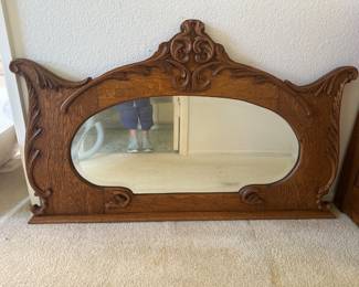 Large ornate wood mirror with beveled oval mirror originally on back of buffet makes a lovely wall accent