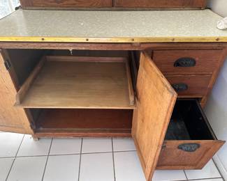 Inside lower section has metal lined right drawer, pull out left shelf