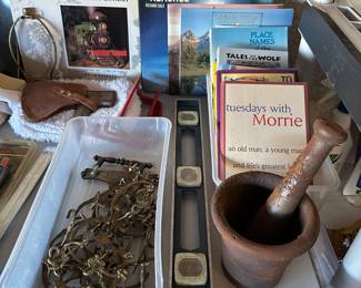Iron mortar and pestle, brass handles, axe with tooled leather holder, level,