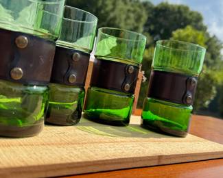 mid-century modern emerald green glass tumblers with leather and brass lion head removable wrap.