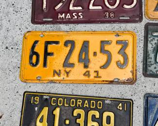 Collection of eight pre-war metal license plates.