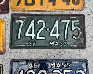 Collection of eight pre-war metal license plates.