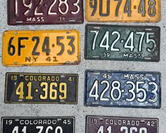 Collection of eight pre-war metal license plates.