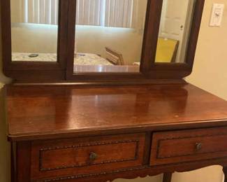 A Beautiful Womans Vanity With Attached Mirror And Two Drawers