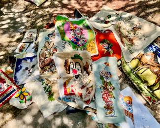 piles of vintage needlepoints. clowns, cats ,horses, flowers , 