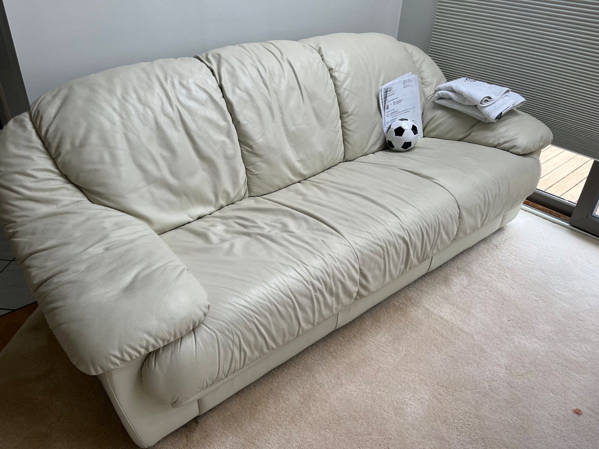 One of two white leather couches 
