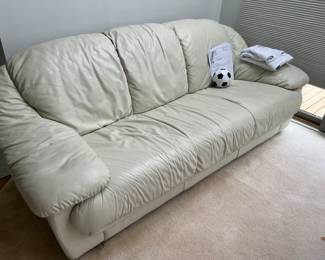 One of two white leather couches 