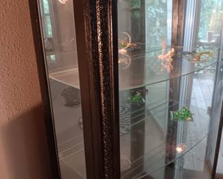 Antique lighted display case with side opening doors.