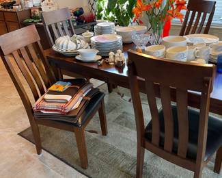 Dining table with self storing leaf.  Comes with 6 chairs.