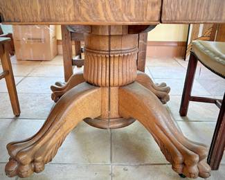 Antique oak dining table with leaf and double clawed feet