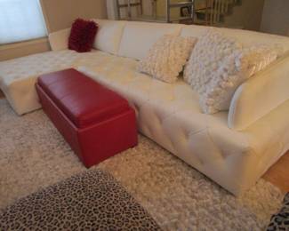 Kasala white leather sofa. Red storage box