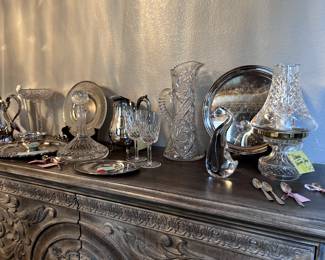 Display of Waterford, etched glass, and Silver collections. Michael Aram gold tea strainer.