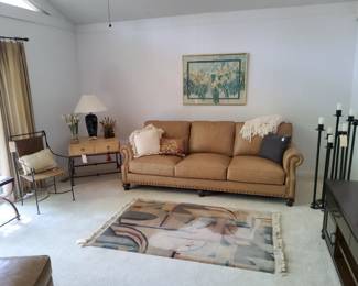 Lexington Furniture Wood and Metal End Table, Craftsman Leather (top grain) Sofa, Abstract Modern Wool Rug, Mid Century Modern Metal Floor Candelabra