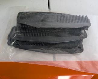 A bundle of clean black plastic combs. Ideal for dramatic play (hair salon), classroom hygiene, or sensory activities.