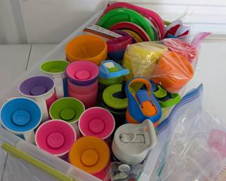 A comprehensive and colorful collection of durable plastic dining ware, perfect for busy preschools, homeschools, or large families! This extensive lot includes a generous assortment of children's plates, bowls, regular cups, various sippy cups/training cups, and baby bottles. All are ready for mealtime, snacks, and drink service. Comes conveniently packed in a large clear storage bin.  Cleaned & Ready for Use