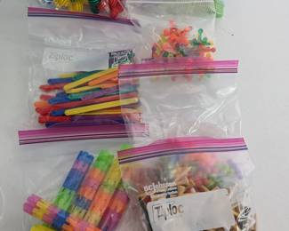A fantastic collection of versatile educational manipulatives and loose parts, ideal for open-ended play, math activities, fine motor skill development, and sensory bins. This large lot includes (but is not limited to): colorful linking blocks, flower/gear shapes, plastic sticks, jacks, and golf tees. All contained in a durable clear storage bin, ready for immediate use in a classroom or homeschool setting.
