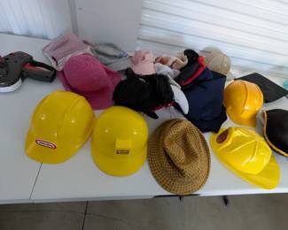Unleash imagination with this fantastic assortment of children's hats, ideal for dramatic play, costumes, and role-playing! This fun collection includes sturdy hard hats (some Little Tikes brand), a graduation cap, a pirate hat, a Spider-Man mask/hat, and various other character and everyday hats. Perfect for sparking creativity in a classroom, homeschool, or home play area.