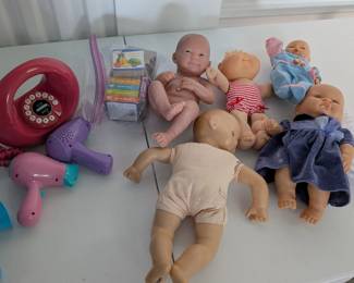 A collection of 5 assorted baby dolls, perfect for nurturing play, learning about caregiving, and encouraging social-emotional development in a dramatic play center. Includes both realistic baby dolls and a charming Cabbage Patch Kid-style doll.