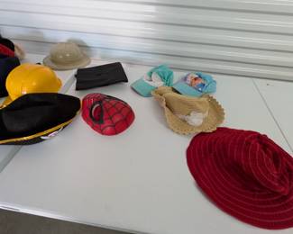 Unleash imagination with this fantastic assortment of children's hats, ideal for dramatic play, costumes, and role-playing! This fun collection includes sturdy hard hats (some Little Tikes brand), a graduation cap, a pirate hat, a Spider-Man mask/hat, and various other character and everyday hats. Perfect for sparking creativity in a classroom, homeschool, or home play area.