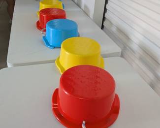 A fun and engaging set of 5 plastic walking stilts, perfect for developing balance, coordination, and gross motor skills in young children. Features sturdy plastic construction with durable rope handles for active play. Ideal for physical education, outdoor play, or a gross motor activity center in a classroom or homeschool setting. (Note: One blue stilt has repaired damage, as shown. All others are in good, usable condition.)