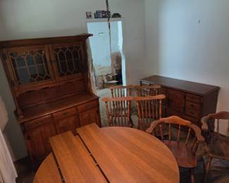 Complete dining room set. Table with 2 leaves, china hutch, buffet cabinet, 2 captain chairs and 4 regular chairs.