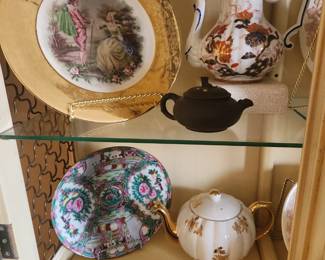 Items sold individually  Porcelain Plate featuring a Romantic Couple with wide gold band edge. Includes stand $20  The brown spots are reflections from above shelf