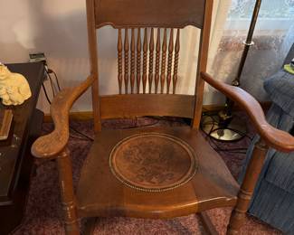 antique rocker with a leather inserted seat