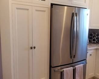 Amish-built custom cabinetry includes a pantry