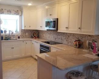 Amish-built U-shaped kitchen with custom cabinetry
