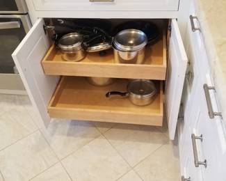 Amish-built custom cabinetry features pull-out shelves
