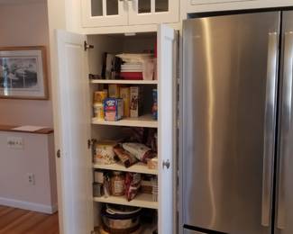 Amish-built custom cabinetry includes a pantry
