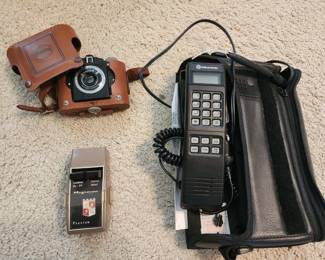 Old technology - bag phone, vintage camera, and early television remote
