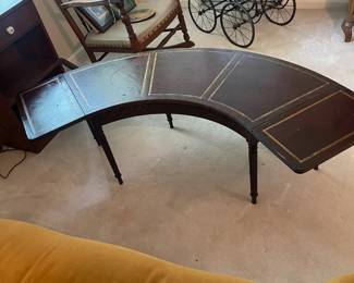R118 - $50. Mahogany Rounded Coffee Table with leather top. Measures 4'wide x 14"deep x 16.5"tall. Drop sides are 11.25" each