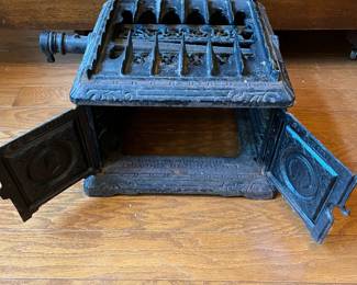 R91 - $60. Small Cast Iron Stove. Measures 12" square x 22" tall.