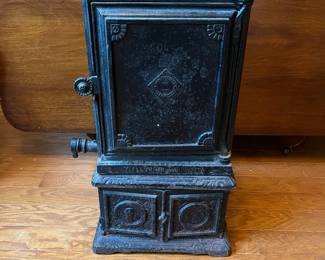 R91 - $60. Small Cast Iron Stove. Measures 12" square x 22" tall.