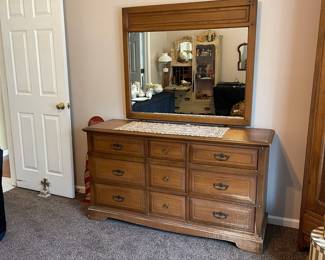 R143 - $50. Dresser with mirror. Drawers all slide but it does have surface damage.