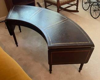 R118 - $50. Mahogany Rounded Coffee Table with leather top. Measures 4'wide x 14"deep x 16.5"tall. Drop sides are 11.25" each