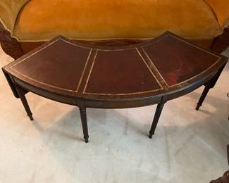 R118 - $50. Mahogany Rounded Coffee Table with leather top. Measures 4'wide x 14"deep x 16.5"tall. Drop sides are 11.25" each