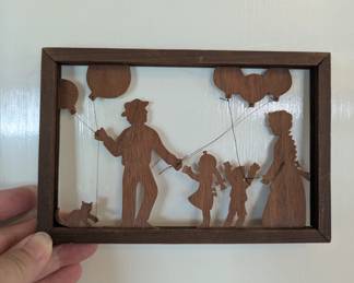 R45 - $10. Carved wooden balloon family.