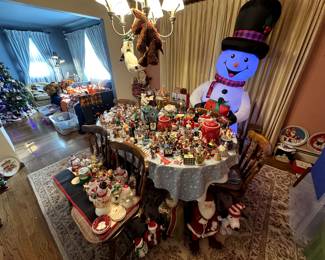 Dining table and chairs, holiday inflatables, Christmas plates, storage bins, shelving