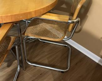 Mid century Cesca style chrome and wood table with chrome and cane chairs. Measures 30" H x 42" diameter. Chairs measure 32"tall at back x 23" widest point. Image 3. Price $850.