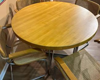 Mid century Cesca style chrome and wood table with chrome and cane chairs. Measures 30" H x 42" diameter. Chairs measure 32"tall at back x 23" widest point. Image 1. Price $850.