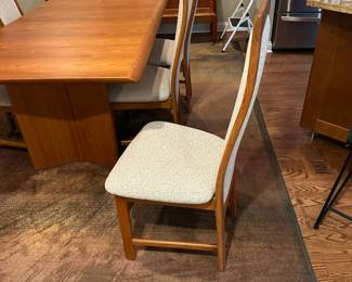1970's Modernist Teak Dining Room Table with 6 Chairs. Includes extra leaf (not shown). Measurements as shown: 31"H x 38"W x 70"L. Chairs measure 42" tall to the top of the back x 19"W at widest point of seat. Image 4. Table and 6 Chairs $2400.